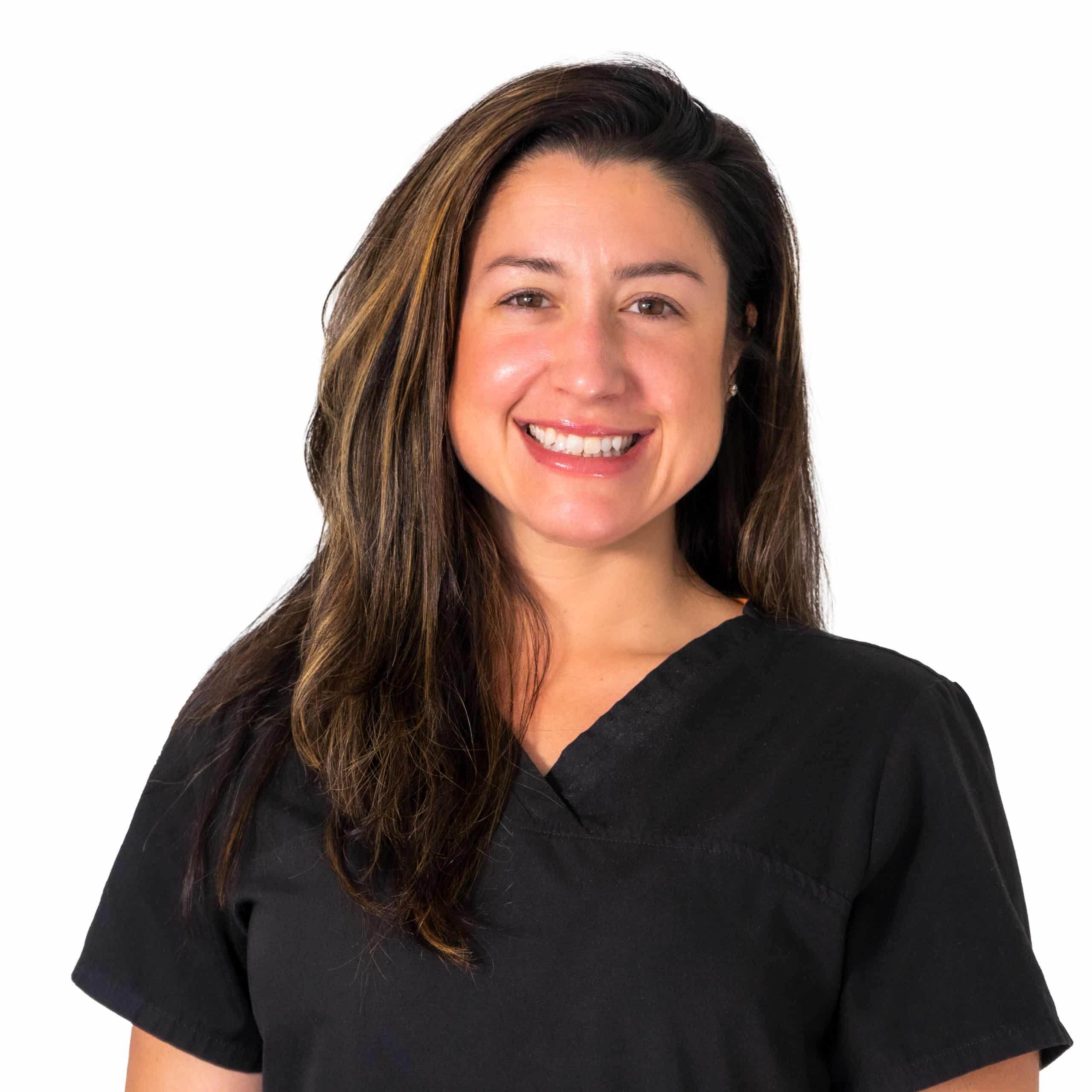 Sarah Cellucci, Surgical Tech at Regeneris Medspa, smiles for the camera in scrubs