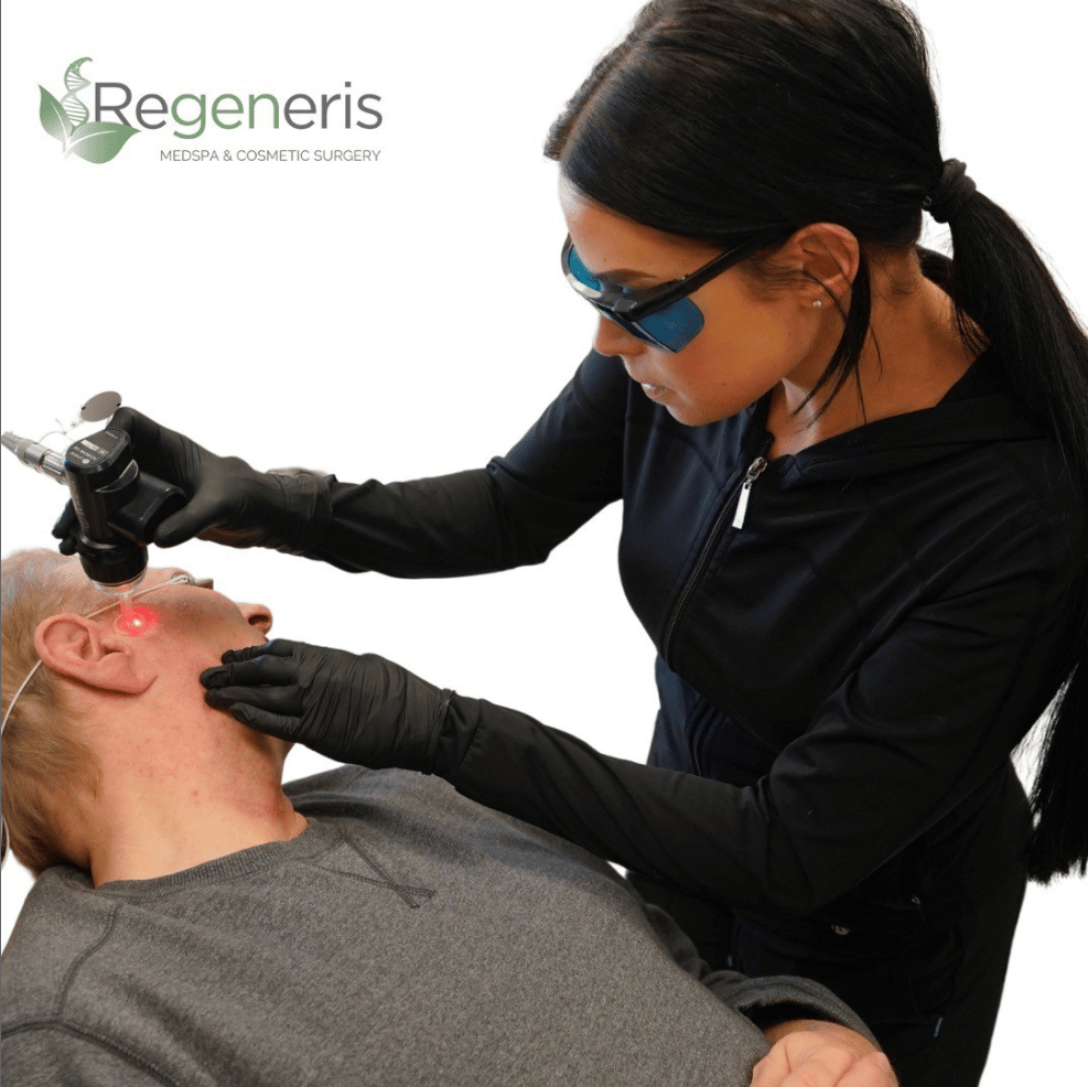 A professional at Regeneris Medspa & Cosmetic Surgery conducting a treatment for a patient