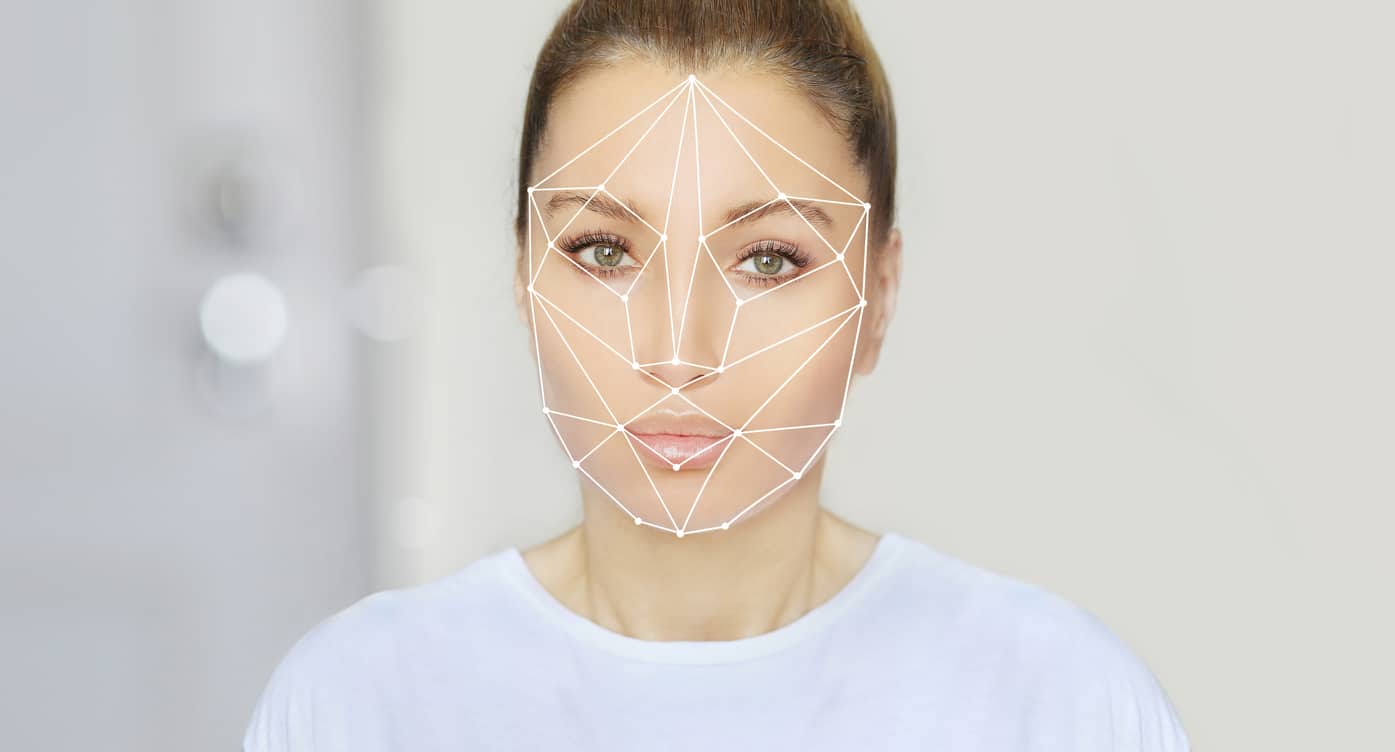 Ideal facial contours are geometrically superimposed over an attractive young woman’s face